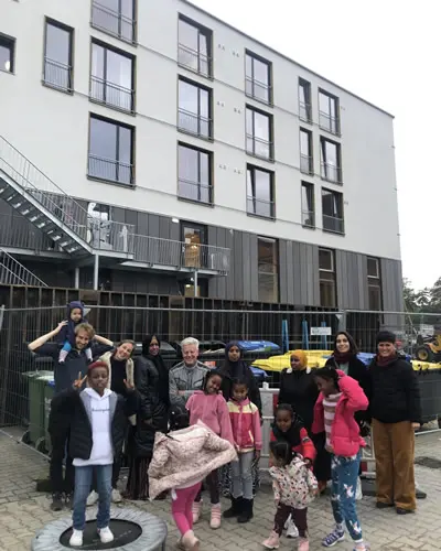 The residents in front of the finished housing project
